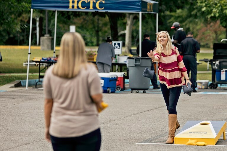 students playing cornhole