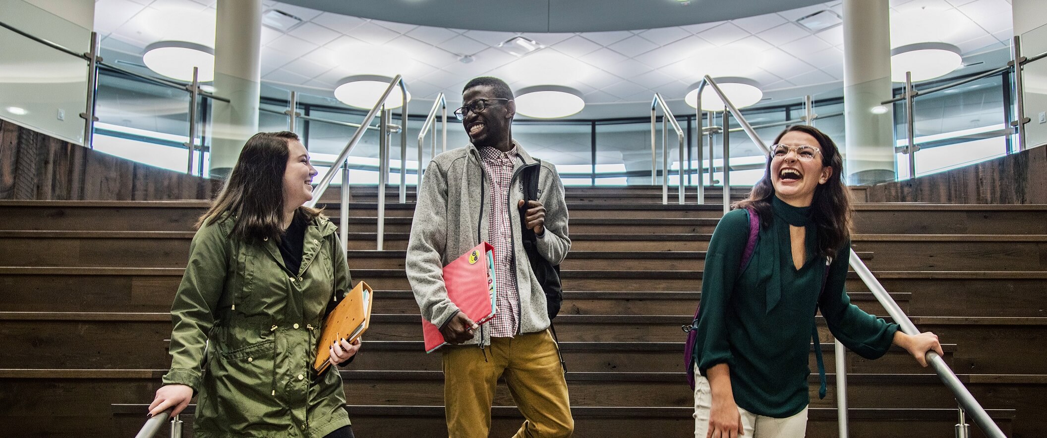three students walking down stairs
